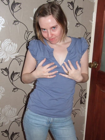 cute blonde posing in jeans and shirt         