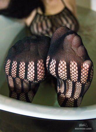 mistress black fishnets feet in bath         
