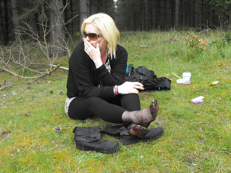 Em showing her sexy feet in the forest in black tights