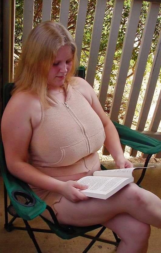 Buxom blonde exposes breasts and thighs as she reads book - 10 Photos 